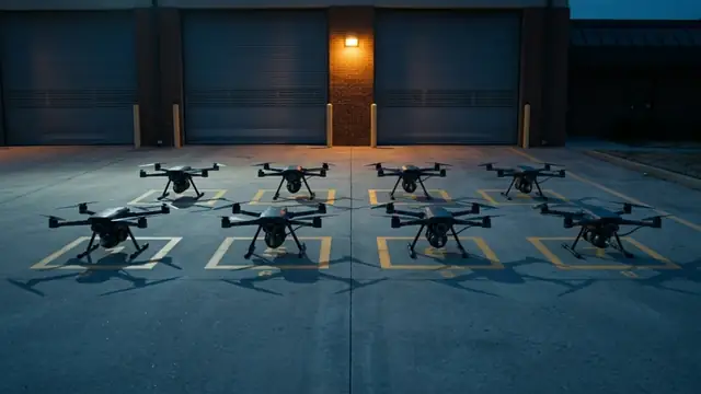 Concept illustration: Caligo drones lined up on marked pads outside a fire station at night.